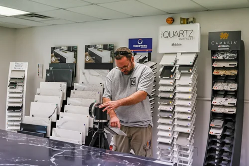 TNT team member setting up laser templating equipment in the showroom