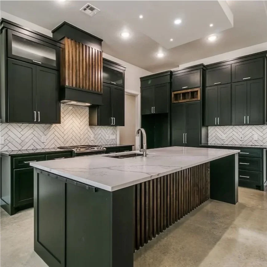 Kitchen with dark cabinetry, a stone island countertop, and a herringbone backsplash