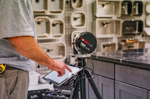 Laser templating instrument and tablet beside a stone countertop